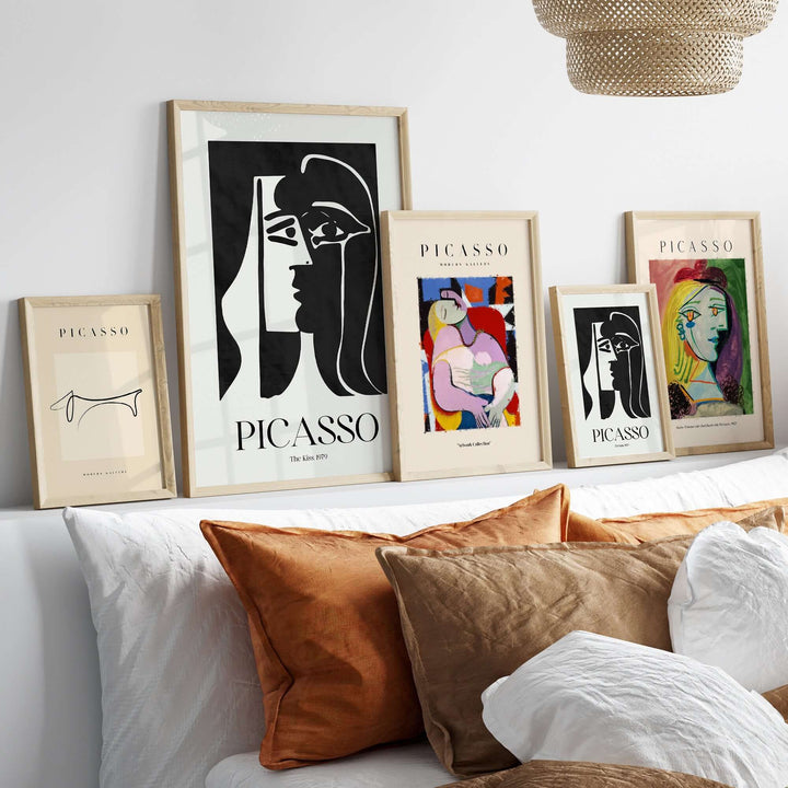 Modern gallery featuring framed Picasso art prints, including 'The Kiss' and abstract portraits in stylish decor.