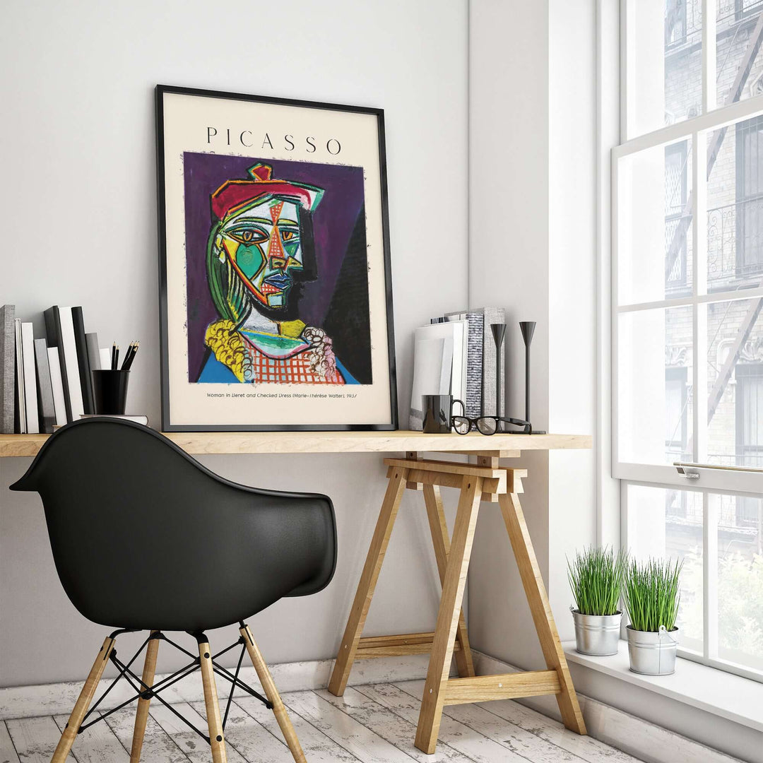 Picasso art print of Marie-Thérèse in beret, displayed in modern office with plants and wooden desk.