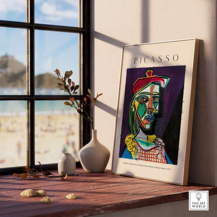Cubist portrait poster of Picasso's 'Woman in Beret and Checked Dress' displayed in a sunlit room.