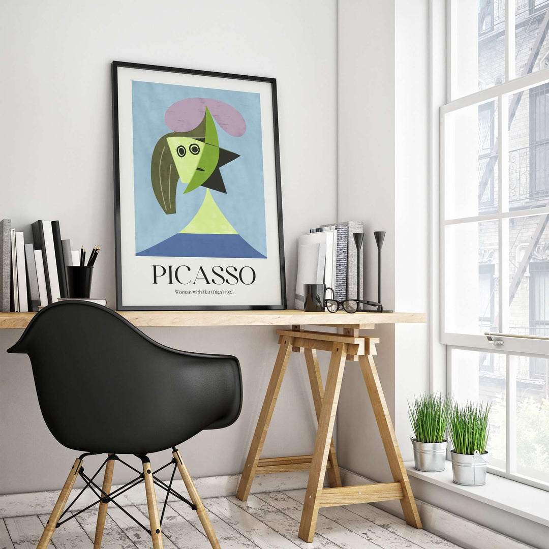 Picasso 'Woman with Hat' 1935 abstract art print in modern office decor with desk and indoor plants.
