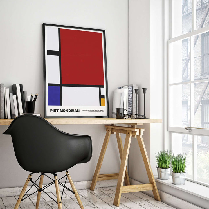 Piet Mondrian abstract art print poster featuring red, blue and yellow, displayed in a modern home office setting.