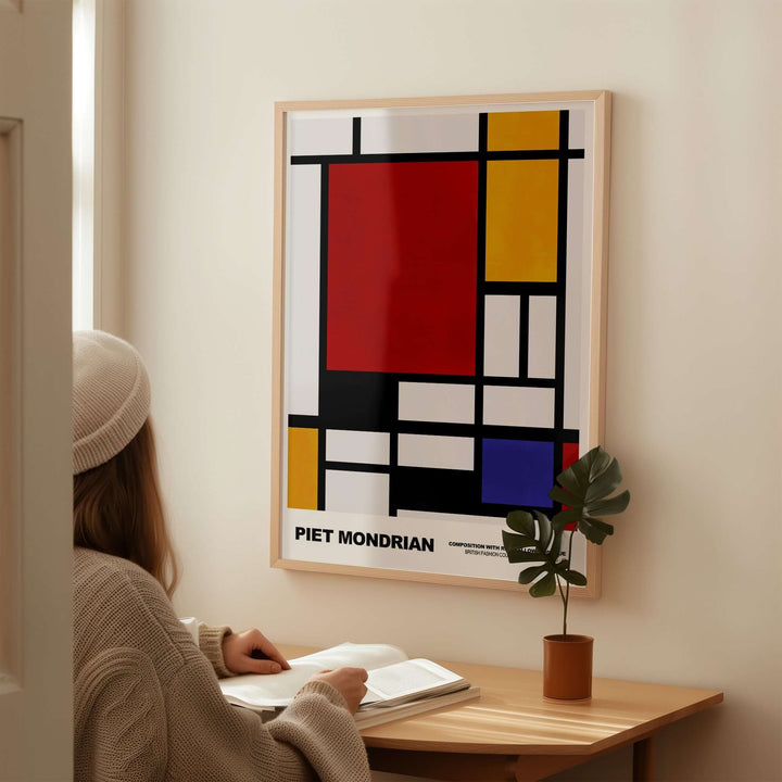 Person admiring Piet Mondrian's Composition Red Yellow Blue 1939 De Stijl poster on wall with geometric patterns.