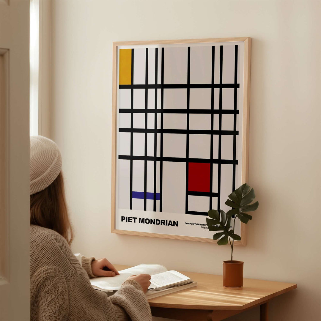 Piet Mondrian 1937 abstract art print with yellow, blue, red blocks and black grid, displayed in a cozy room.
