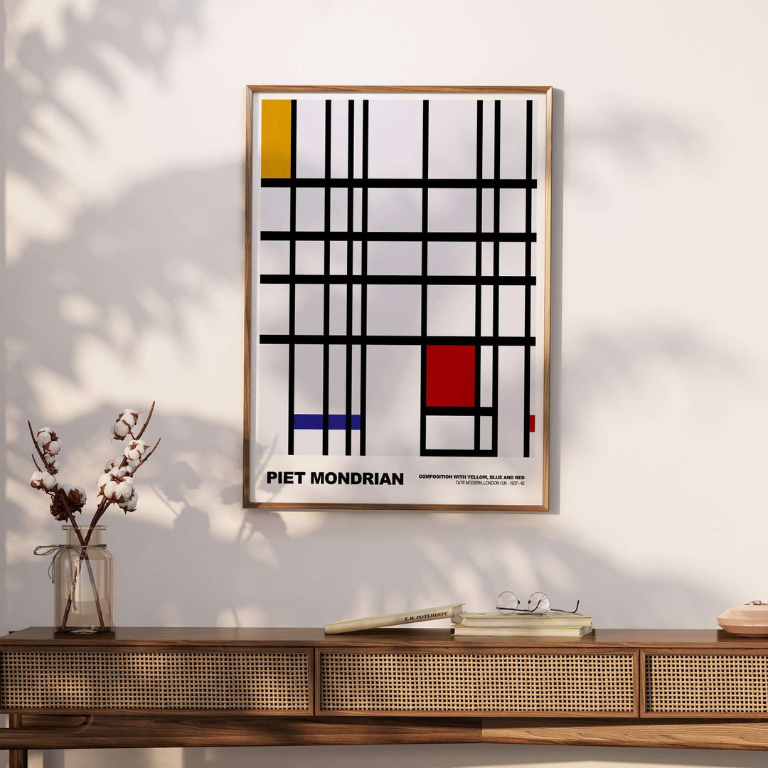 Piet Mondrian abstract art print featuring yellow, blue, red blocks and black lines in a geometric grid design.