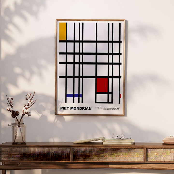 Piet Mondrian abstract art print featuring yellow, blue, red blocks and black lines in a geometric grid design.