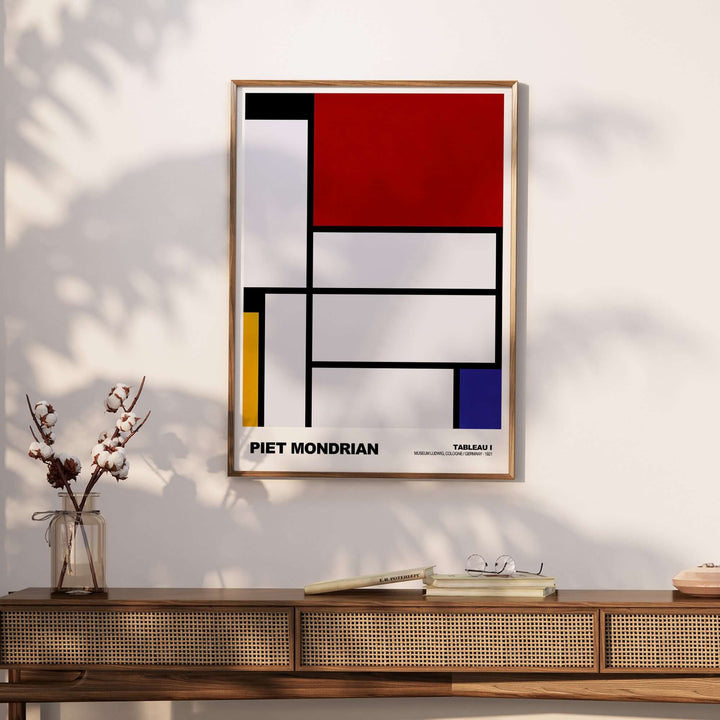 Piet Mondrian Tableau I 1921 abstract geometric poster on wall, featuring primary colors and black lines.