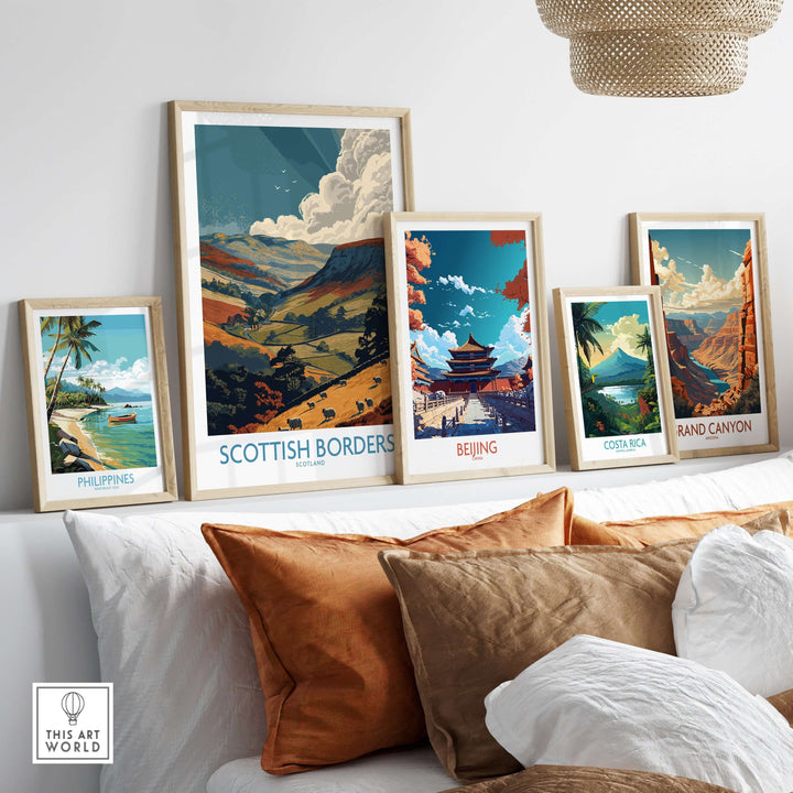 Framed travel posters featuring landscapes from Scottish Borders, Beijing, Costa Rica, and Grand Canyon on a sofa.