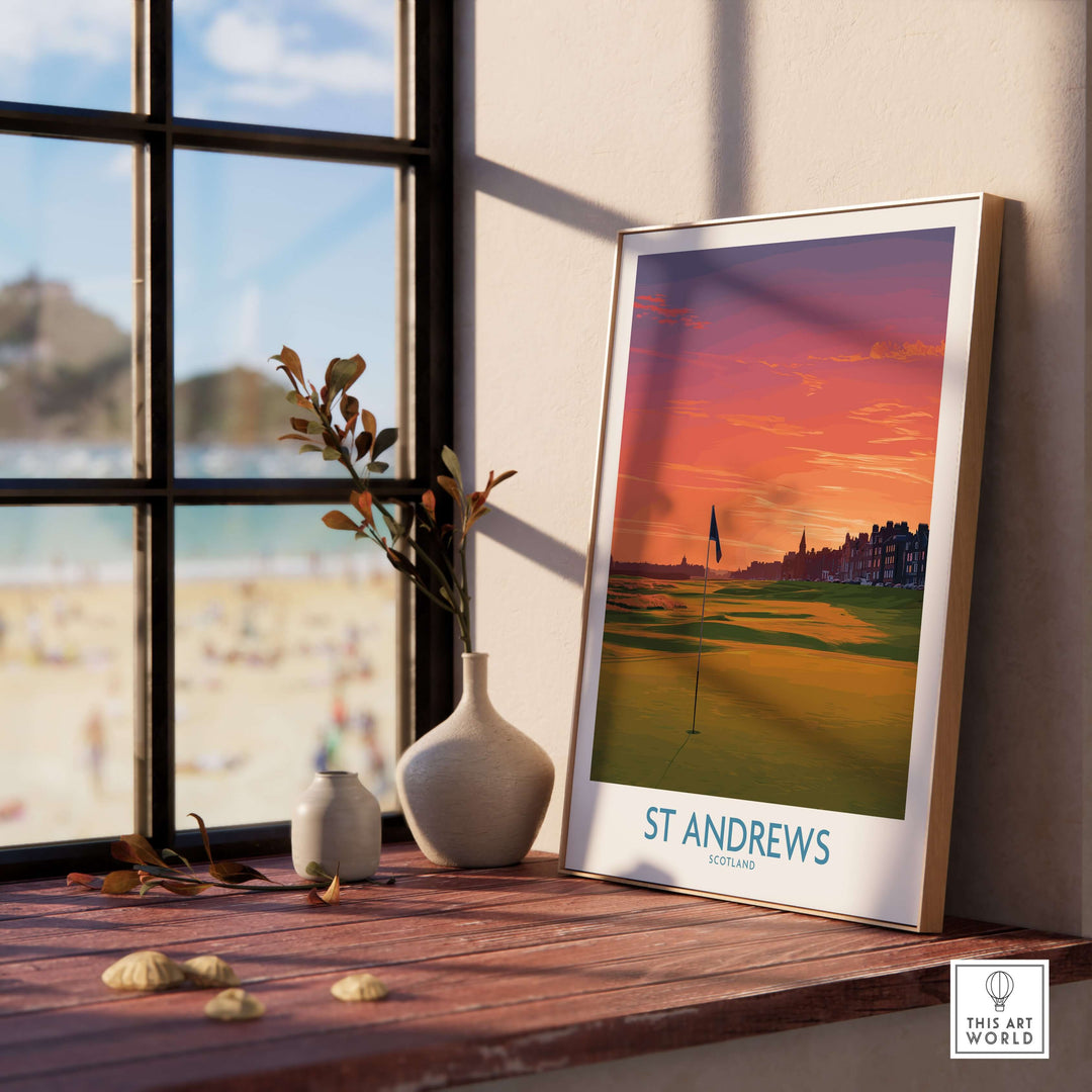 St Andrews Scotland Golf Course Wall Art poster print displayed on a wooden table with beach view in the background.