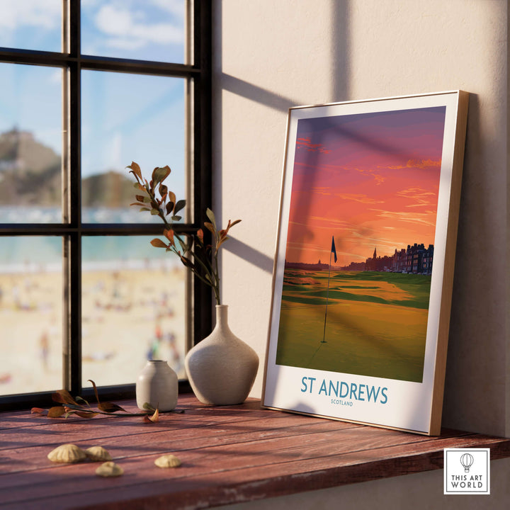 St Andrews Scotland Golf Course Wall Art poster print displayed on a wooden table with beach view in the background.