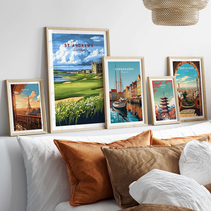 St Andrews Scotland Old Course sunset poster among framed travel prints on a stylish modern bed with decorative pillows.