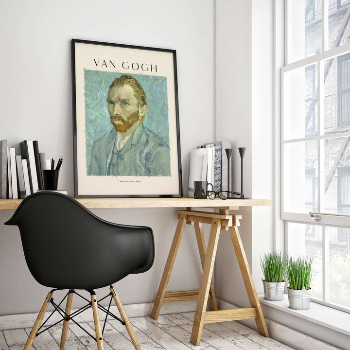 Vincent van Gogh 1889 self-portrait art print framed on a modern desk in a bright room.