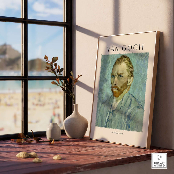 Vincent van Gogh Self Portrait 1889 art print displayed on a table by a window with beach view.