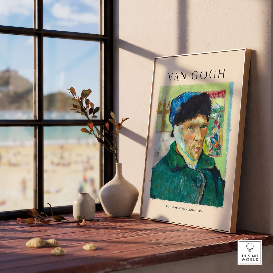 Vincent van Gogh Self Portrait with Bandaged Ear art print displayed on a table by a window with beach view.