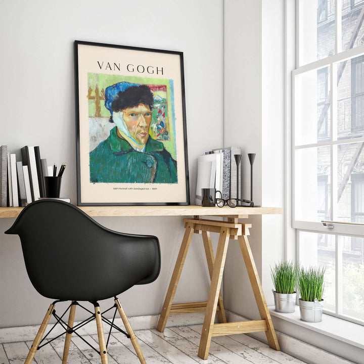 Vincent van Gogh art print poster on a desk in a modern room, featuring a self-portrait with bold colors.