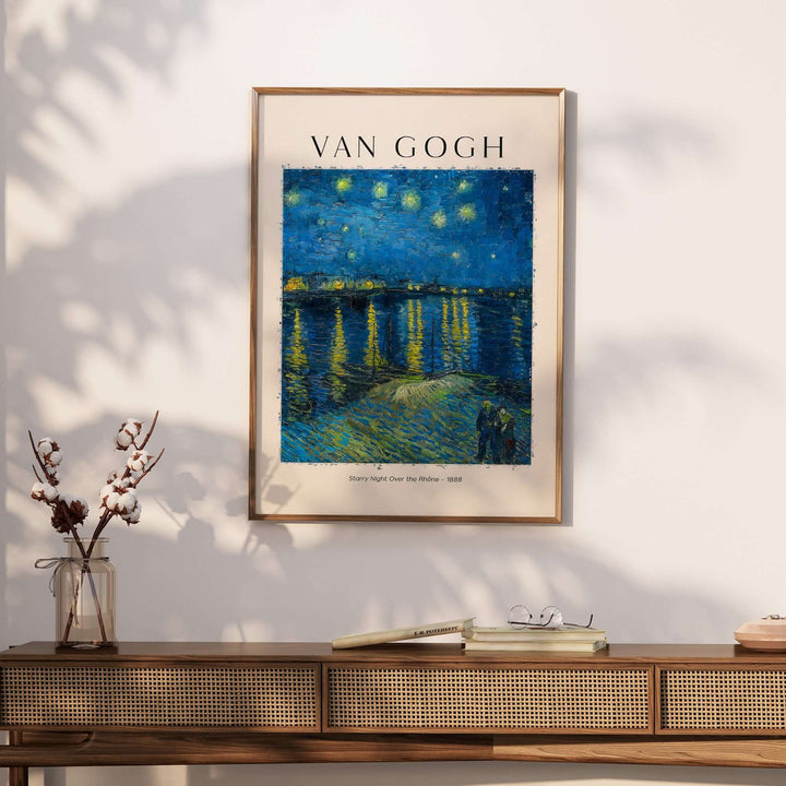 Vincent van Gogh Starry Night Over the Rhône 1888 poster print framed on a wall with a modern wooden console.