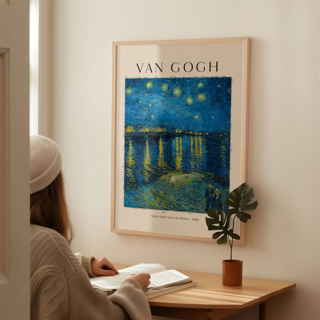 Woman admiring Vincent van Gogh's Starry Night Over the Rhône art print on a wall in a cozy setting.