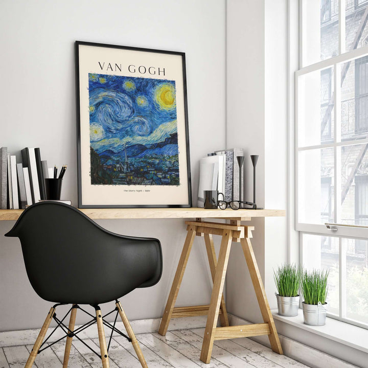 Vincent van Gogh The Starry Night art print poster displayed in a modern workspace with black chair and plants.