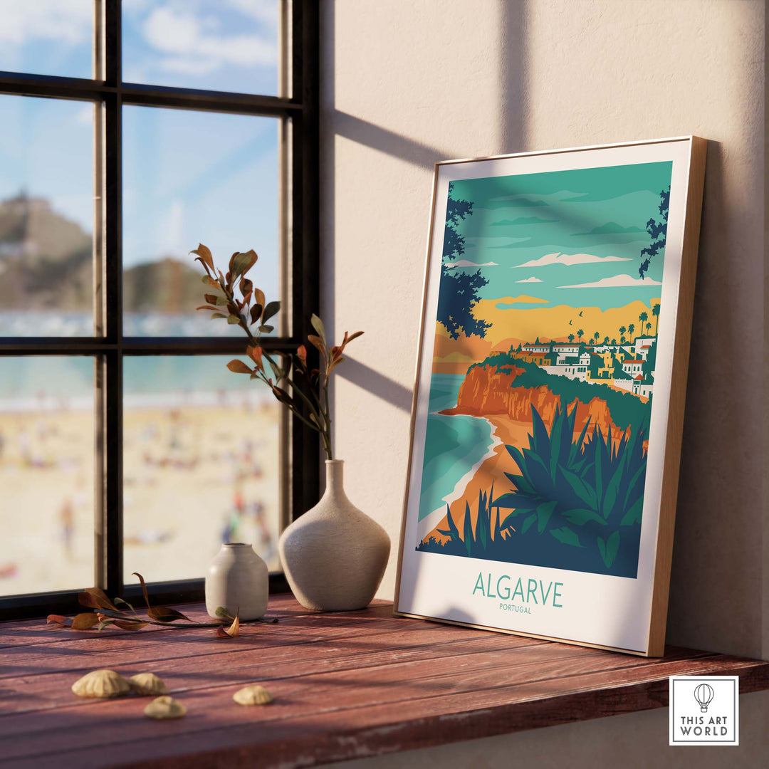 Algarve Print Portugal framed on a wooden table, showcasing coastal scenery and inspired vintage travel art.