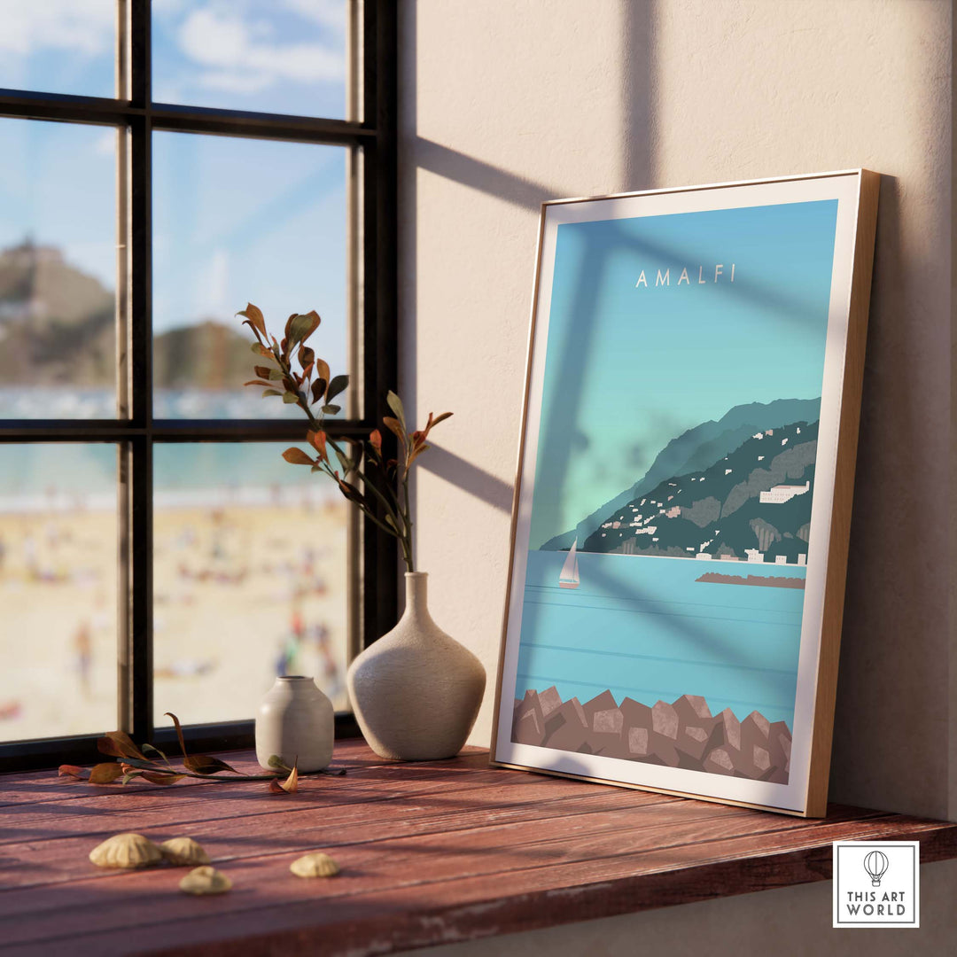 Amalfi Coast Italy print displayed in a stylish interior setting next to a beach view, showcasing vintage travel art.