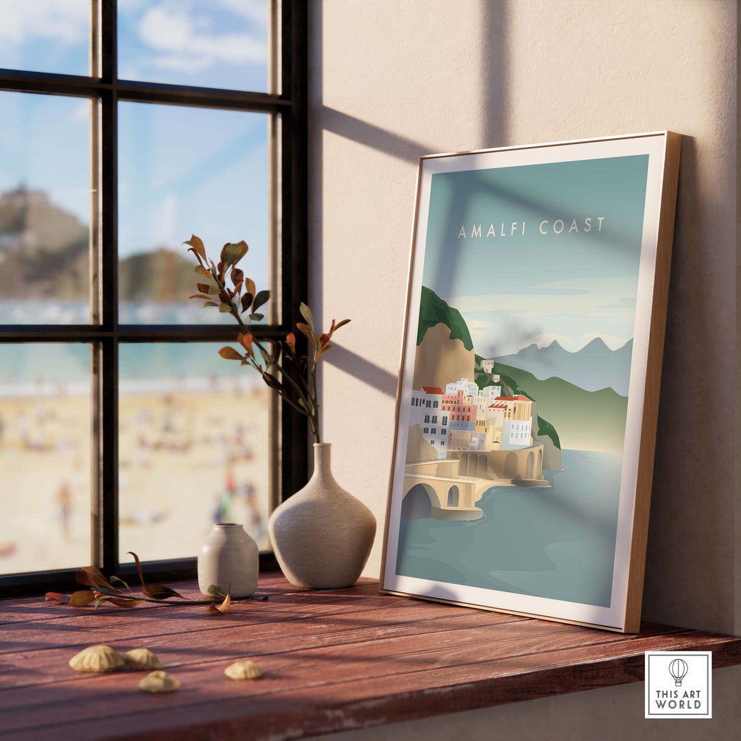 Amalfi Coast minimalist print framed on desk, showcasing vintage travel art in a stylish interior setting.