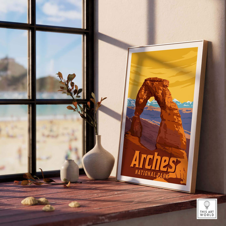Framed Arches National Park print displayed on a desk near a window, showcasing vintage-inspired wall art.