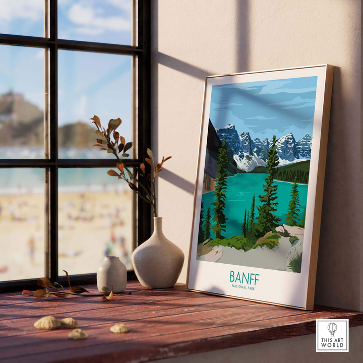 Banff National Park vintage poster print displayed on a wooden shelf with a view of the outdoors.