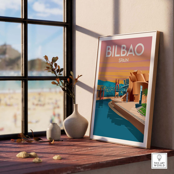 Art print of Bilbao, Spain displayed on a table with a beach view, framed in minimalist style.