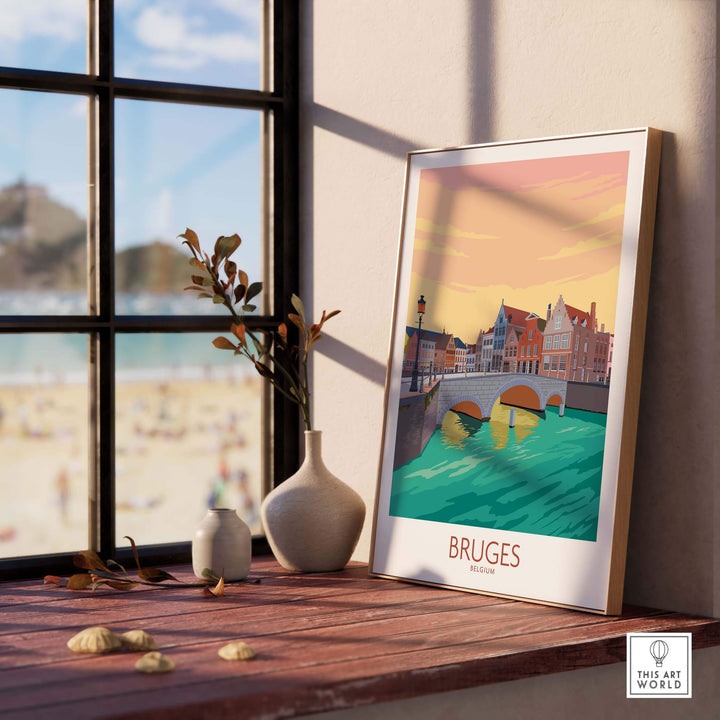 Bruges Belgium vintage travel poster on a stylish table by the window, showcasing serene canal views and colorful architecture.