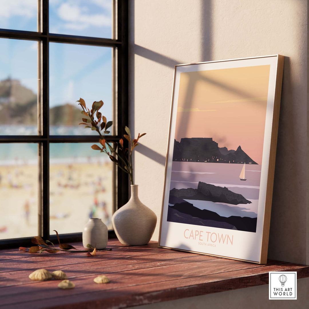 Cape Town vintage poster print displayed near a window with Table Mountain and beach view.
