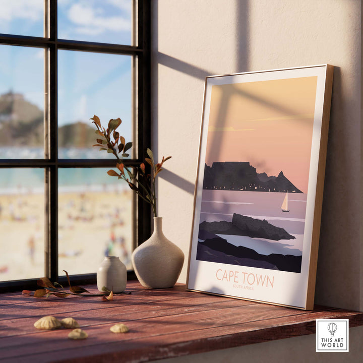 Cape Town vintage poster print displayed near a window with Table Mountain and beach view.