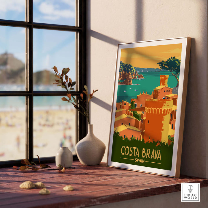 Costa Brava Print Spain showcased in a bright room, featuring a vintage-style travel poster and coastal scenery.