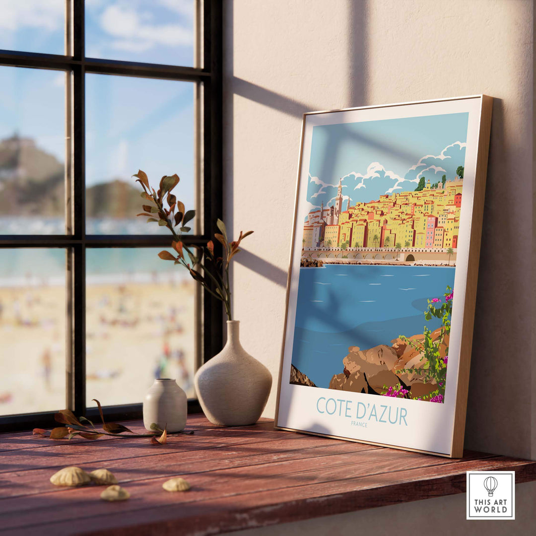 Cote d'Azur print poster displayed indoors by a window, capturing vintage travel art vibes and modern decor.