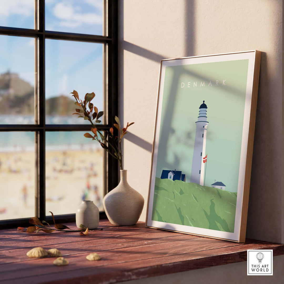 Denmark Print Wall Art Poster featuring a lighthouse, displayed in a bright room with a beach view.