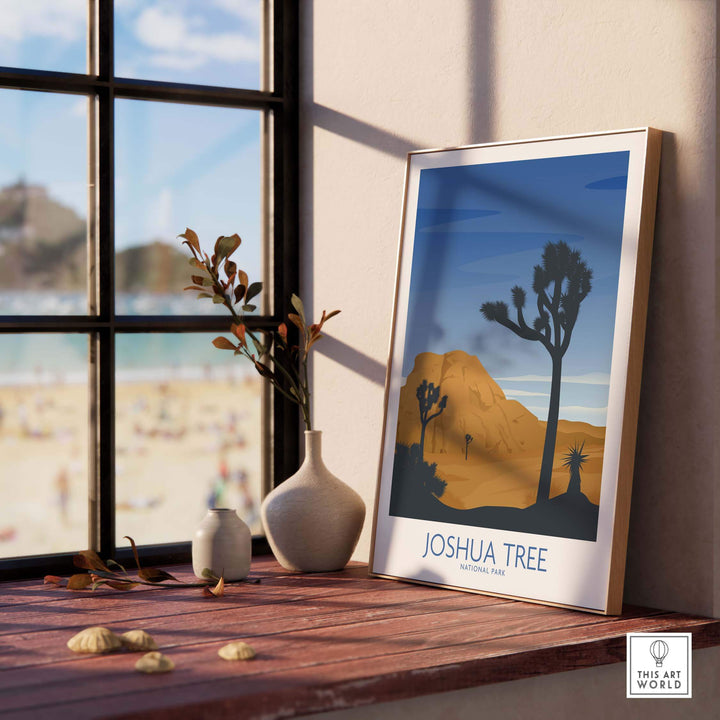 Joshua Tree National Park art print framed on a table, showcasing a minimalist design of desert landscapes and trees.