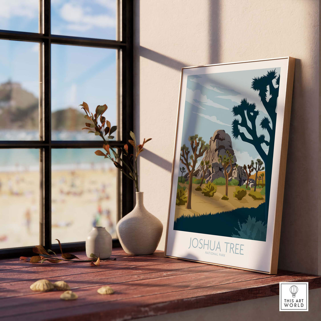 Framed Joshua Tree Park poster print displayed on a windowsill with a scenic beach view.