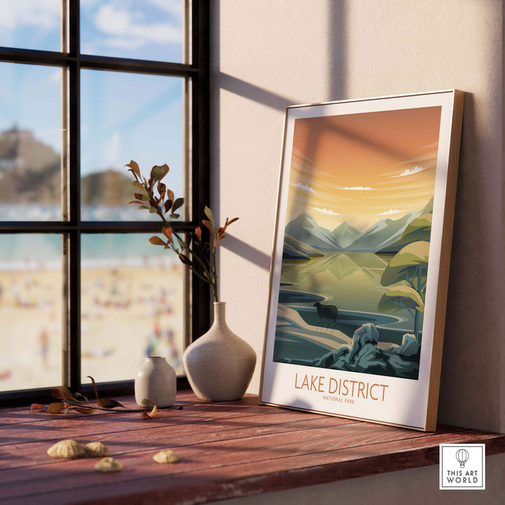 Lake District National Park art print displayed on a wooden table by a window, showcasing minimalist landscape design.