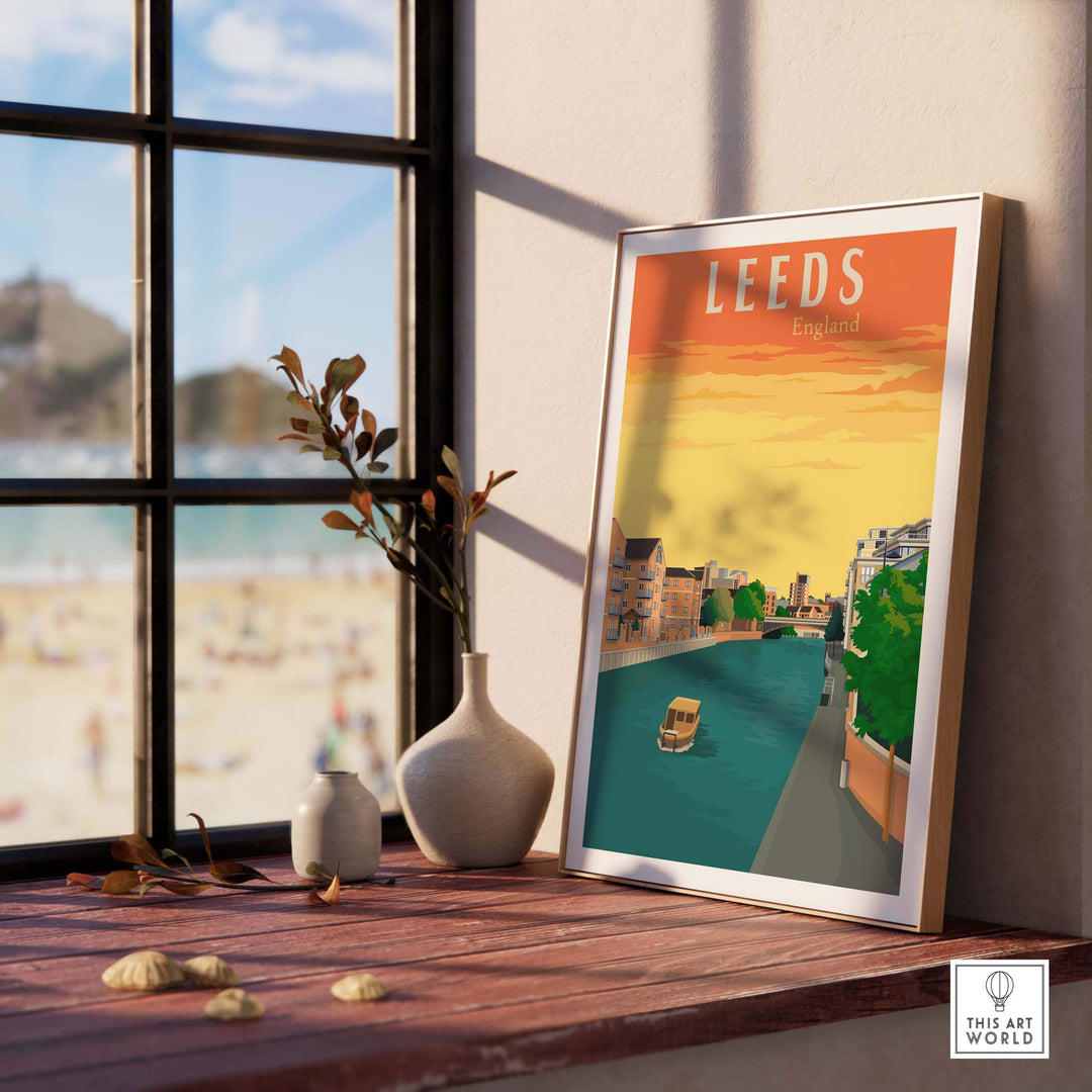 Leeds Poster Print displayed on a wooden table near a window, showcasing vintage travel art inspired by England.