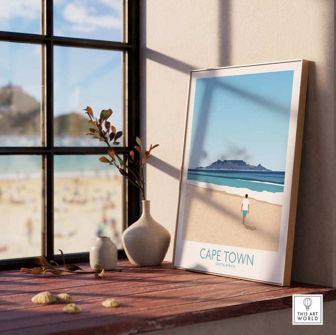 Cape Town Wall Art Print featuring a beach scene, framed and placed on a windowsill with natural light.