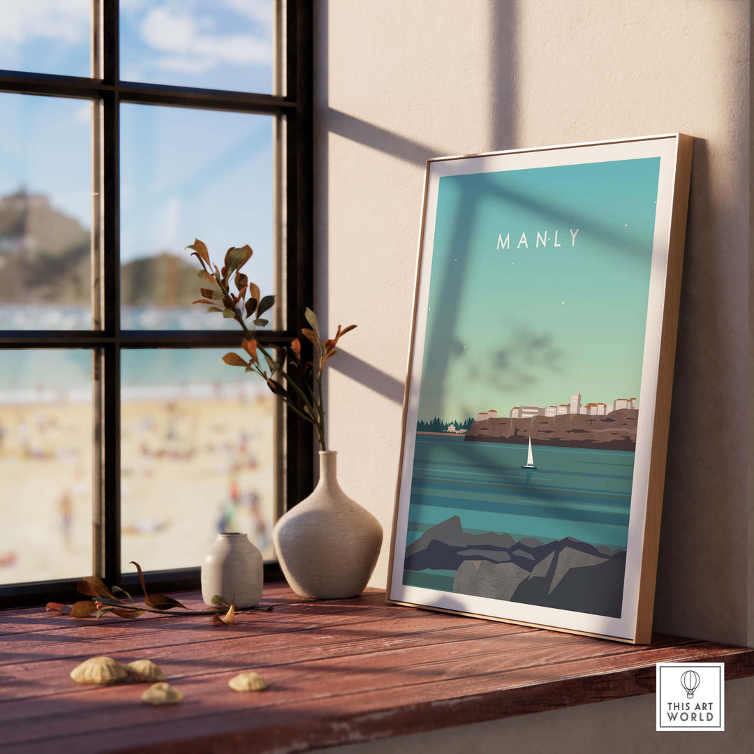 Framed Manly Australia poster print displayed on a windowsill, showcasing vintage travel art and coastal scenery.