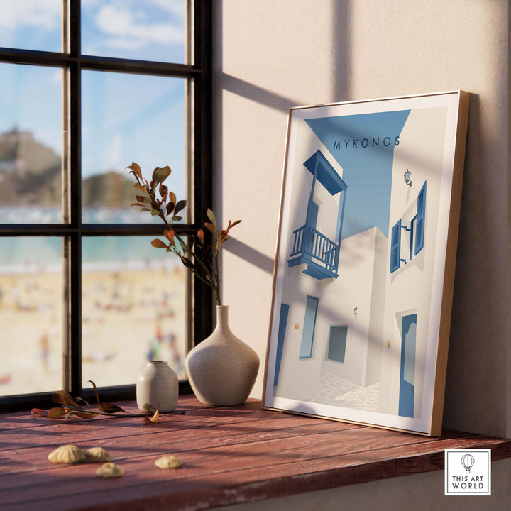 Mykonos wall art poster framed in a sunny room with a beach view, showcasing vintage Greek island charm.