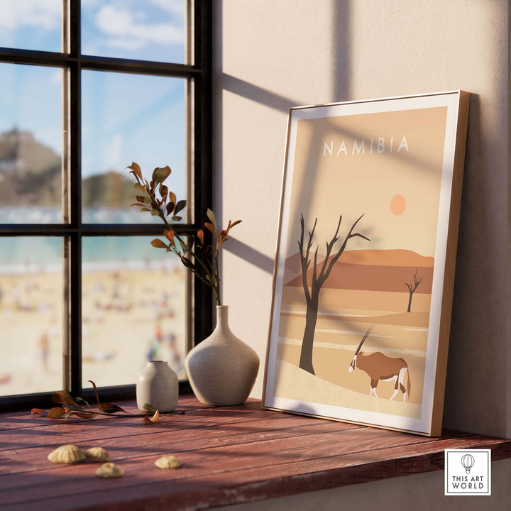 Namibia Print Dunes Poster displayed on a wooden table with a vase and window view, adding stylish decor to any space.
