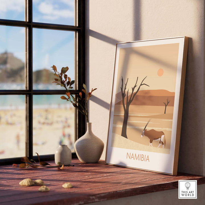 Namibia travel poster print showcasing desert scenery with wildlife, framed and styled decor in a modern setting.