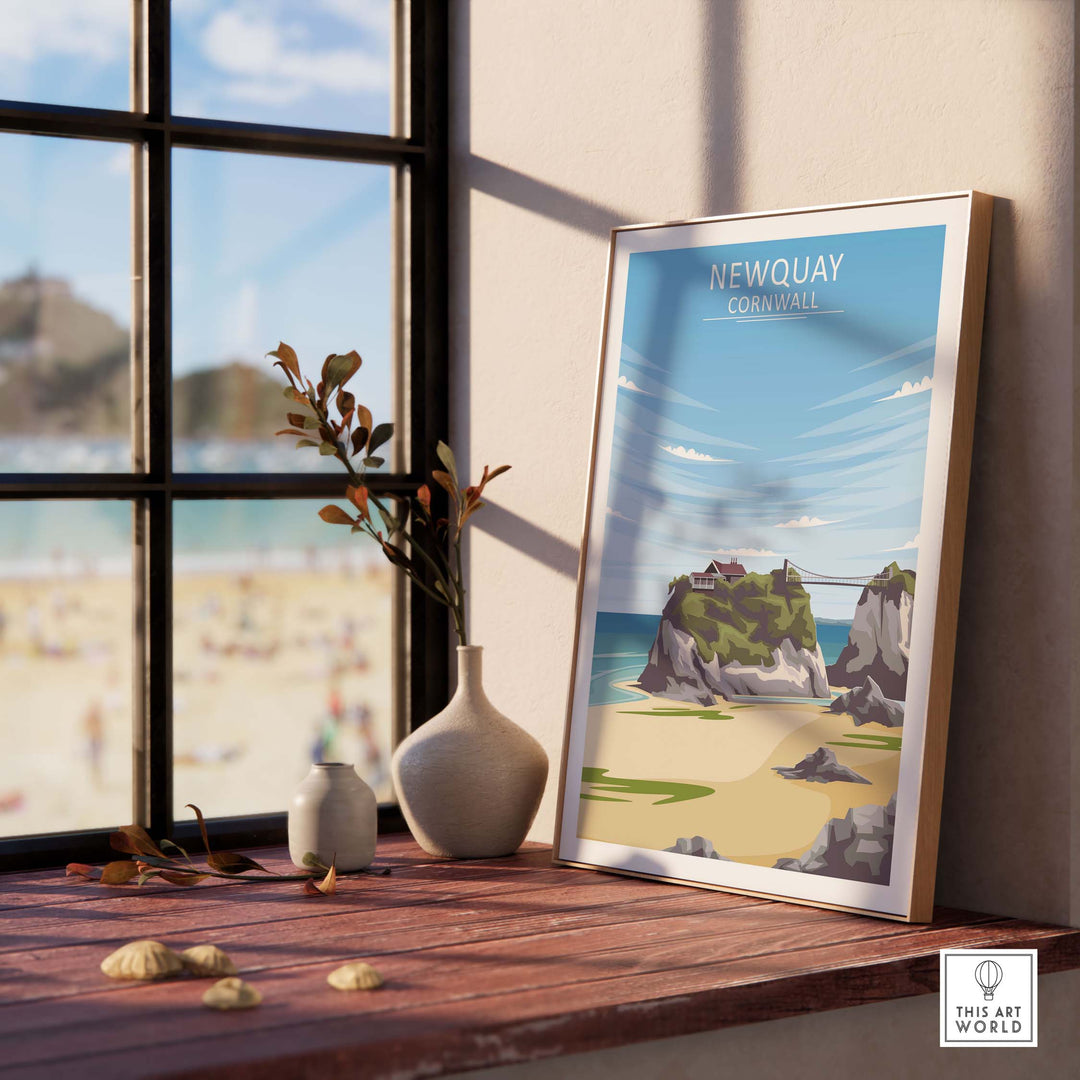 Framed Newquay Print Cornwall poster on a table by a window, showcasing coastal art and beach scene.