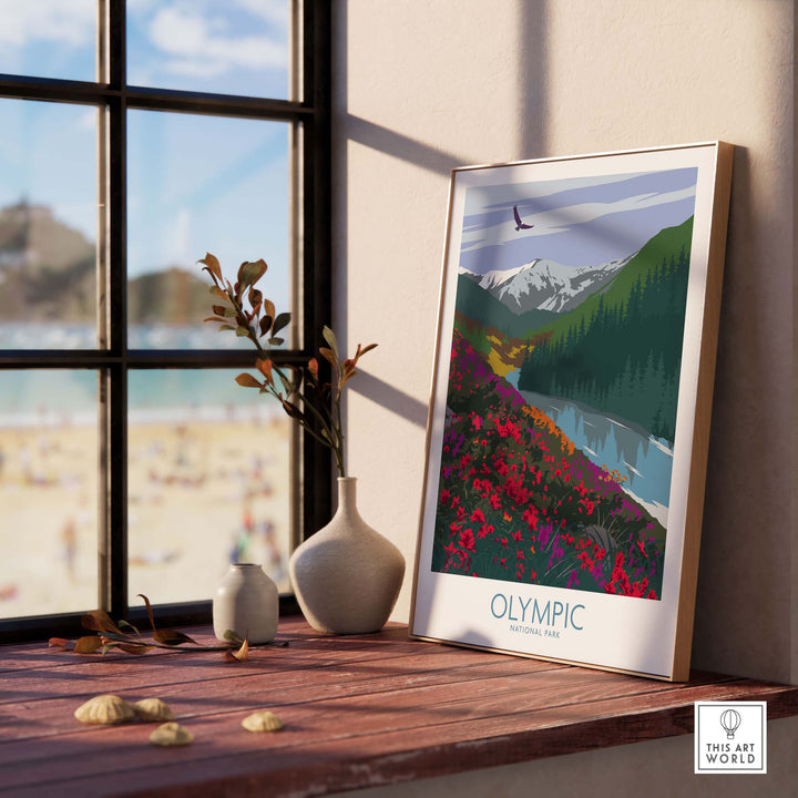 Olympic National Park art print displayed on a wooden shelf with beach view through window.