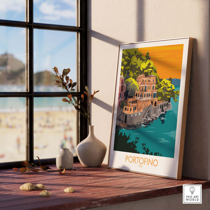 Portofino print travel poster displayed by a window, showcasing vintage travel art and coastal scenery.