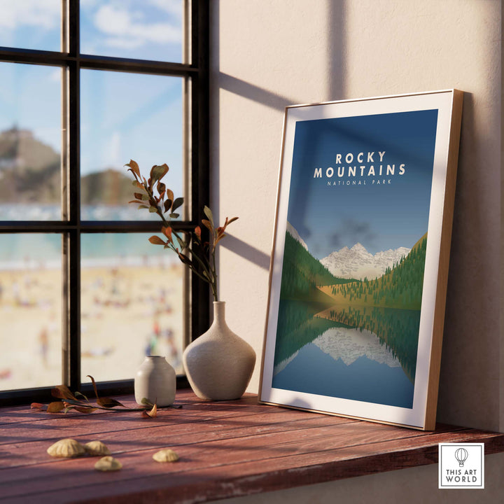 Framed Rocky Mountains National Park art print displayed indoors with beach view, showcasing minimalist design and nature.
