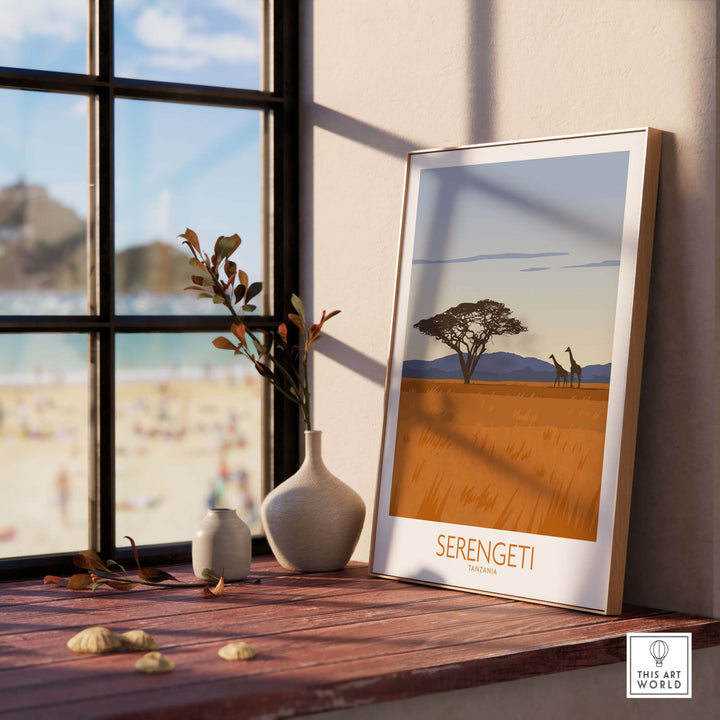 Framed Serengeti National Park poster print on a sunlit windowsill, showcasing vintage travel art.