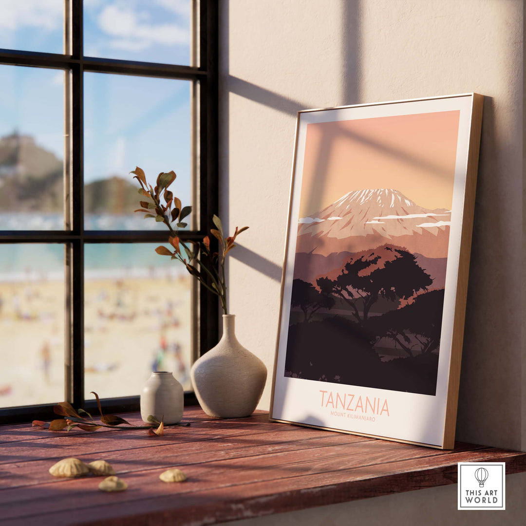 Kilimanjaro Print Tanzania Poster framed on a windowsill with beach view, showcasing vintage travel art.