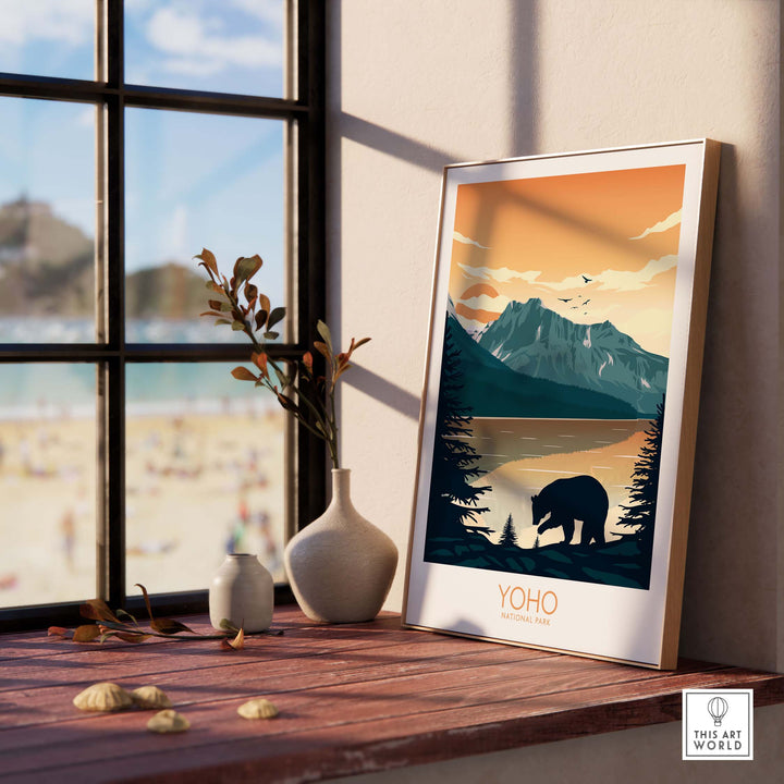 Yoho National Park poster featuring mountains and a bear, displayed indoors by a window, elegant art print for decor.