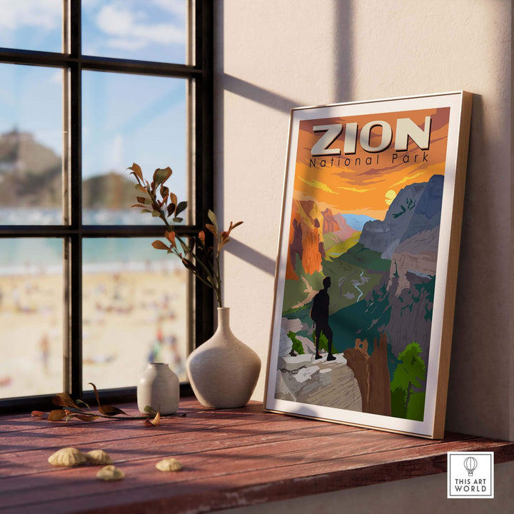 Zion National Park poster framed on a shelf near a window, showcasing vibrant outdoor scenery and wanderlust inspiration.